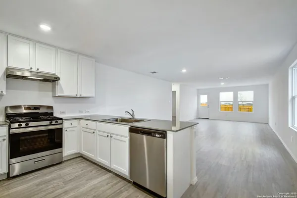 a kitchen with a stove and a sink