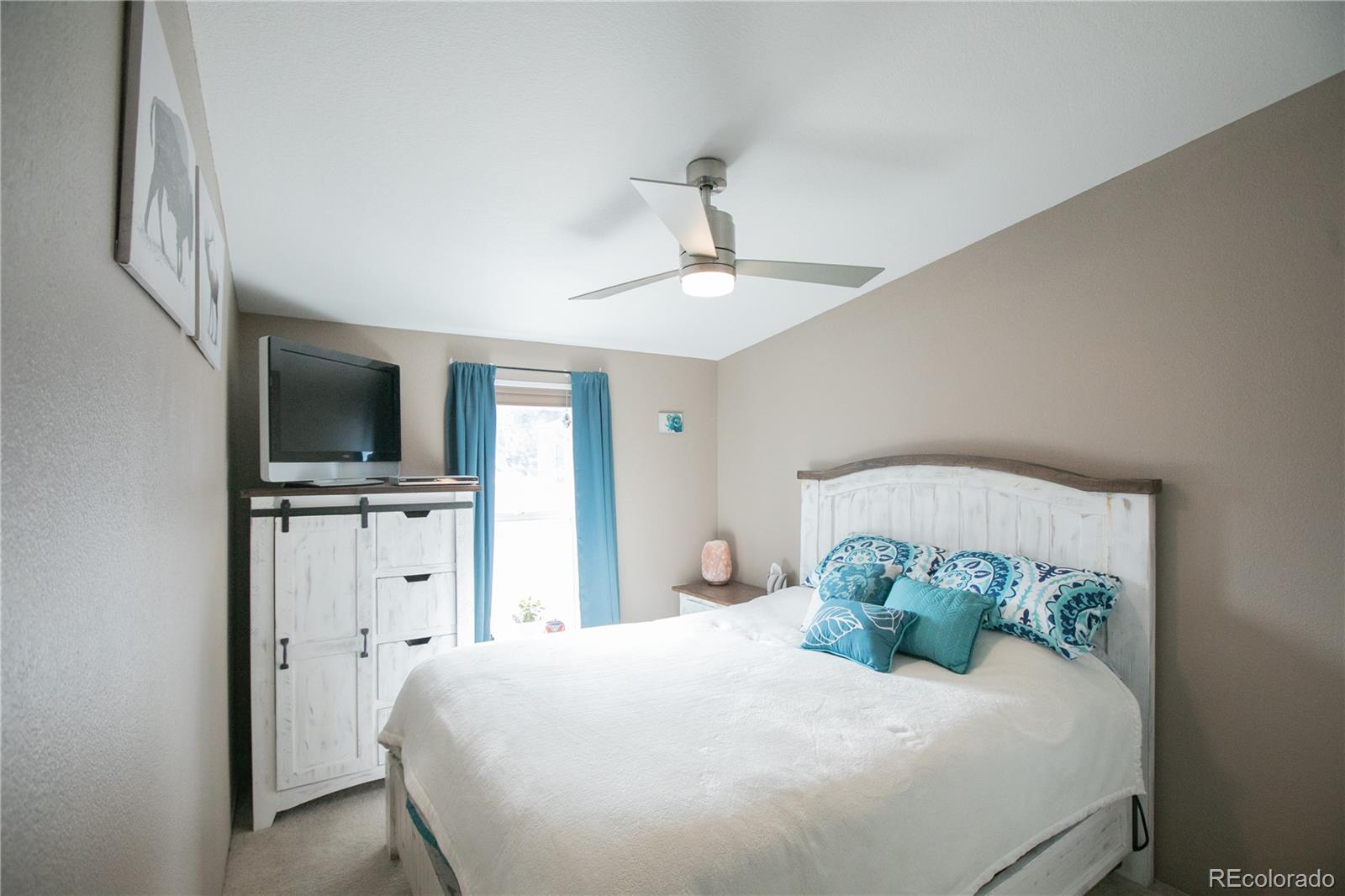 143 Sombrero Road Hartsel, CO 80449 - Photo 13 of 25 a bedroom with a bed and a flat screen tv
