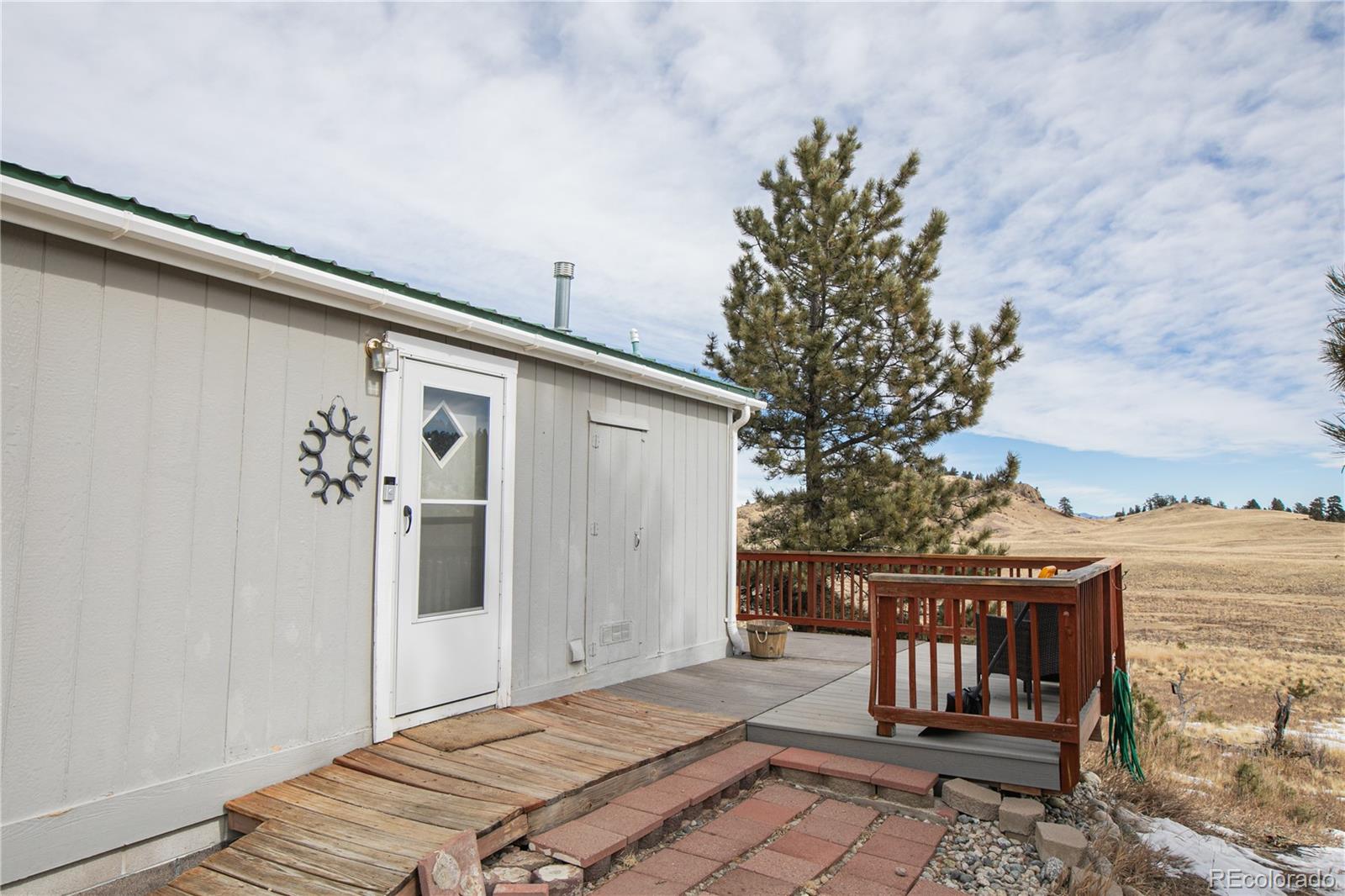 143 Sombrero Road Hartsel, CO 80449 - Photo 18 of 25 a bedroom with a bed and a potted plant