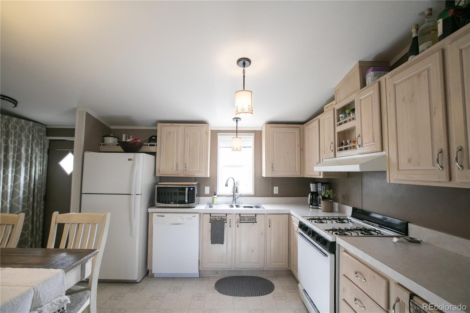 143 Sombrero Road Hartsel, CO 80449 - Photo 6 of 25 a kitchen that has a lot of white cabinets and stainless steel appliances