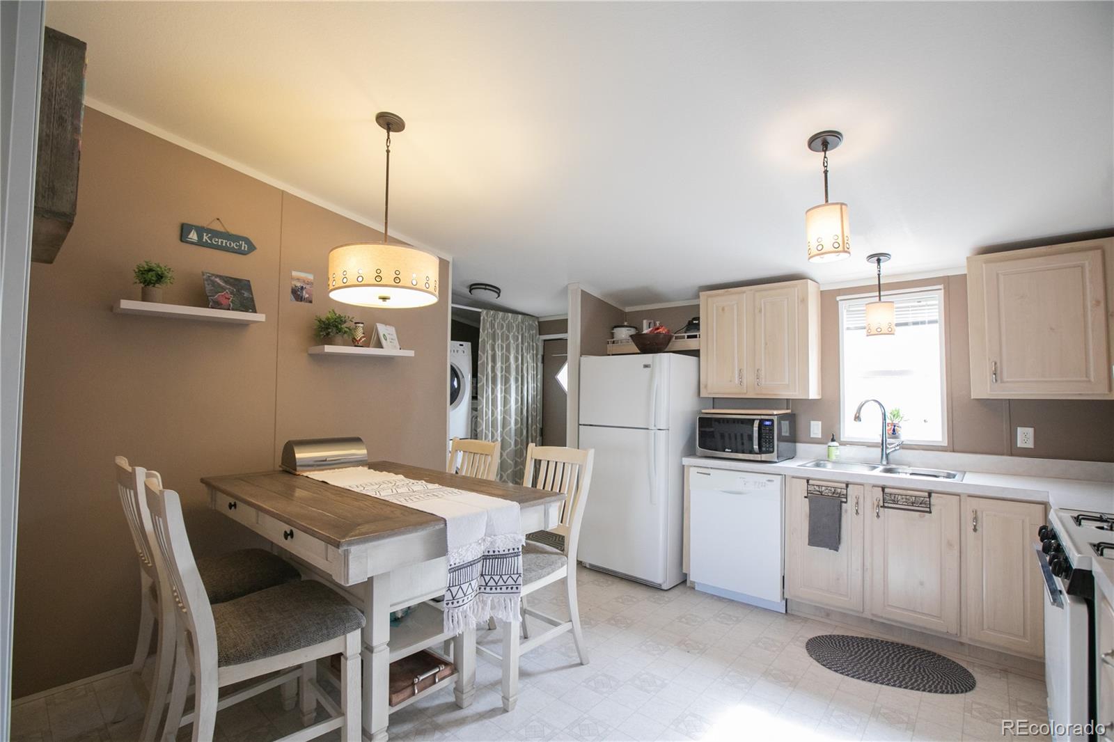 143 Sombrero Road Hartsel, CO 80449 - Photo 7 of 25 a kitchen that has a table chairs and a refrigerator