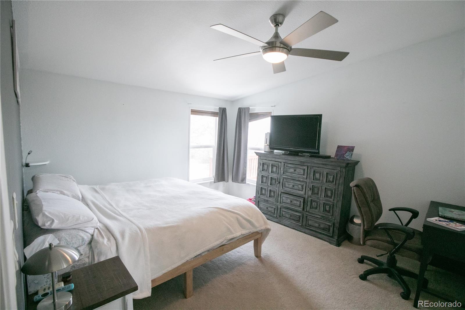 143 Sombrero Road Hartsel, CO 80449 - Photo 10 of 25 a bedroom with a bed and a flat tv screen on a dresser
