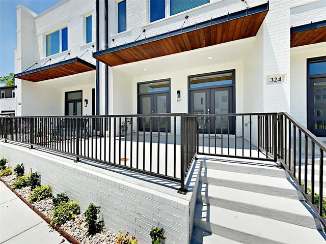 a view of a house with a wooden fence