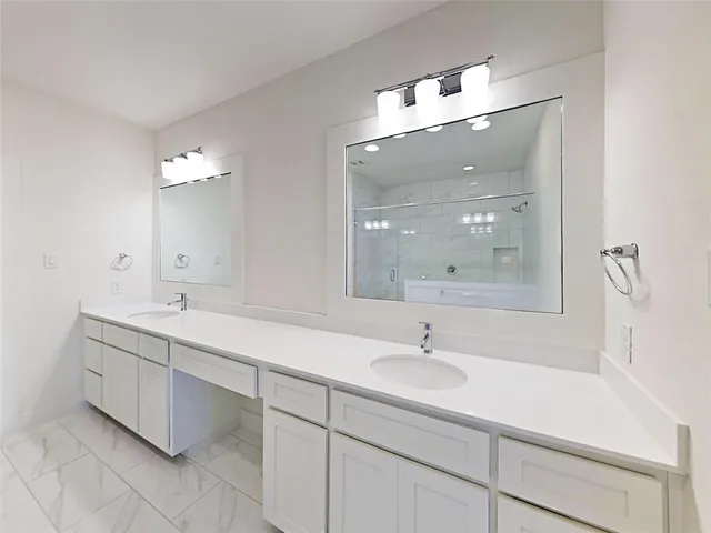 a bathroom with a double vanity sink and mirror