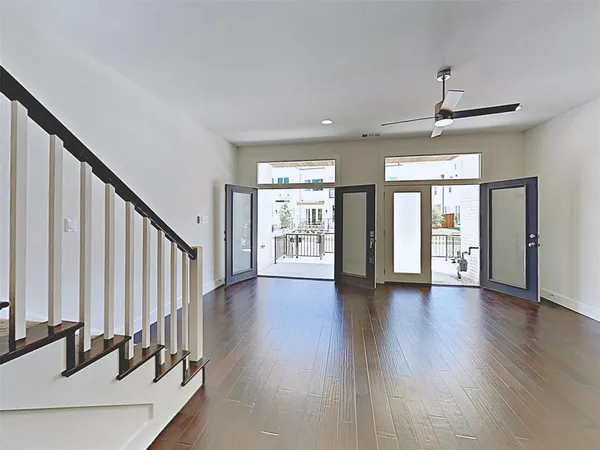a view of an entryway with wooden floor and door