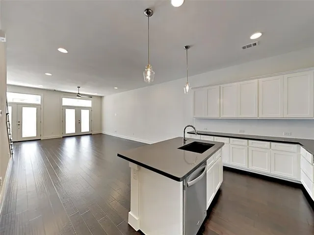a kitchen area with granite countertop a stove and a sink
