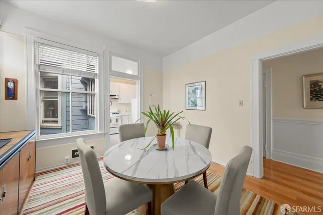 a kitchen with stainless steel appliances white cabinets and a stove top oven