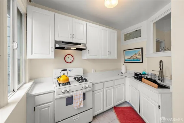 a kitchen with a refrigerator and a sink