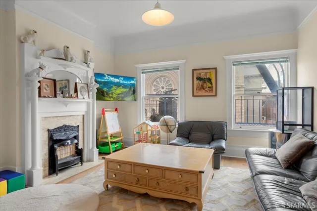 a living room with furniture and a fireplace