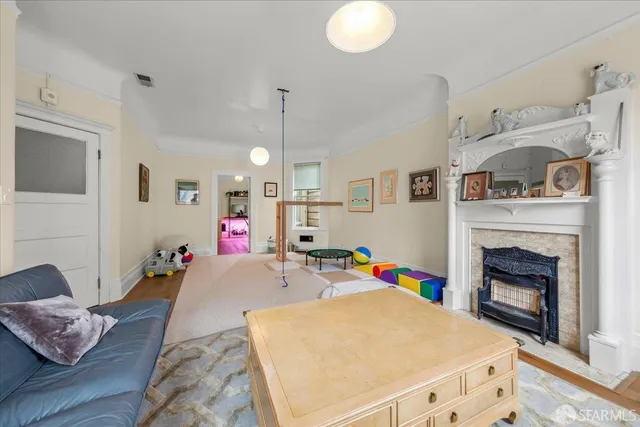 a living room with furniture and a book shelf