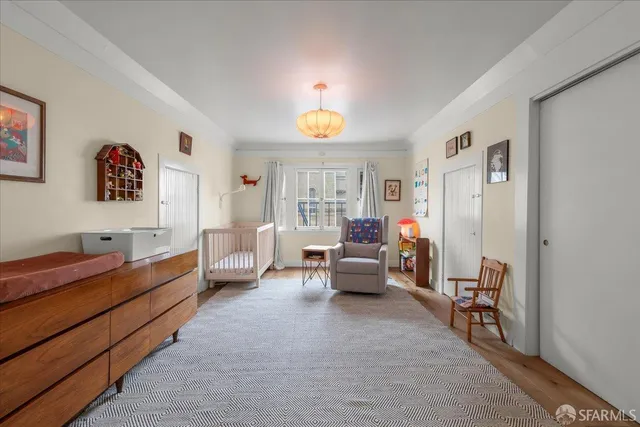 a kitchen with stainless steel appliances granite countertop a refrigerator a stove top oven a sink dishwasher and white cabinets with wooden floor