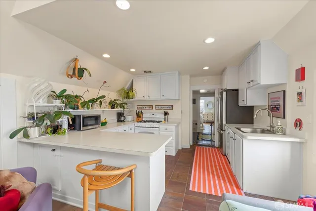 a living room with furniture and kitchen view