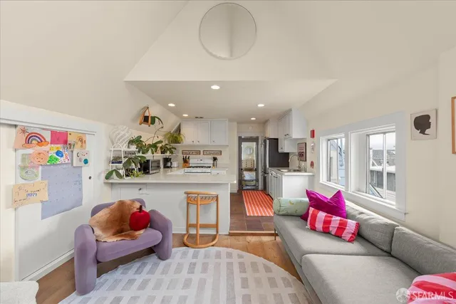 a living room with furniture and kitchen view