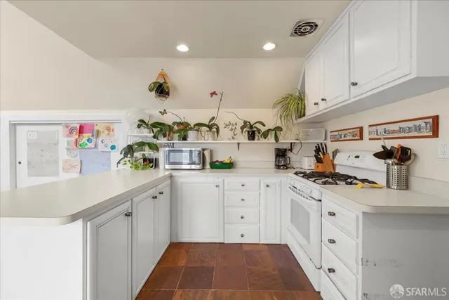 a bathroom with a granite countertop toilet sink and mirror