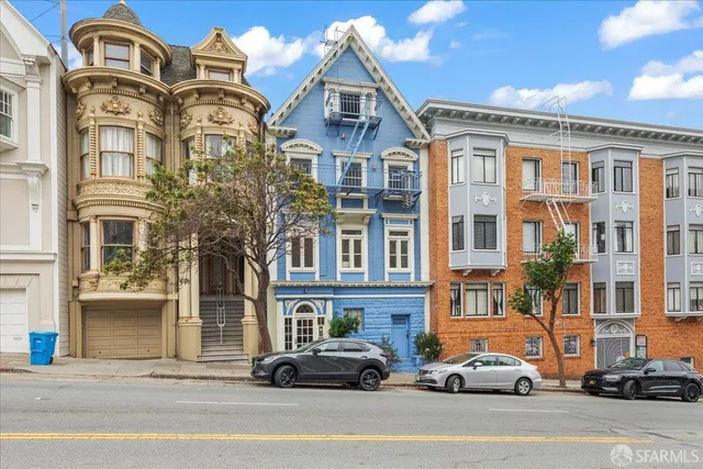 a front view of a multi story residential apartment building with a yard