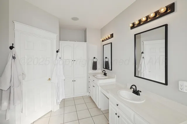 a bathroom with a double vanity sink a mirror and shower