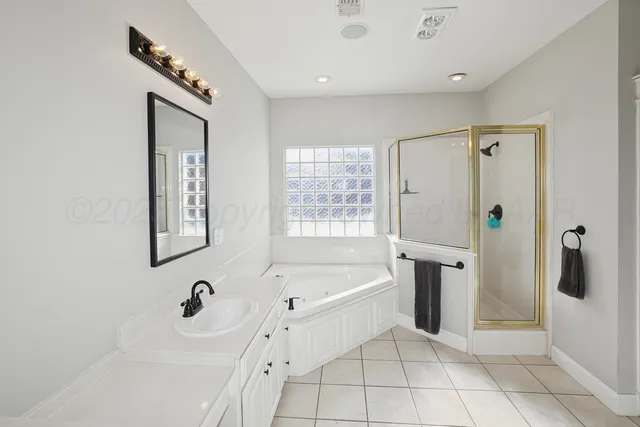 a bathroom with a tub sink and mirror