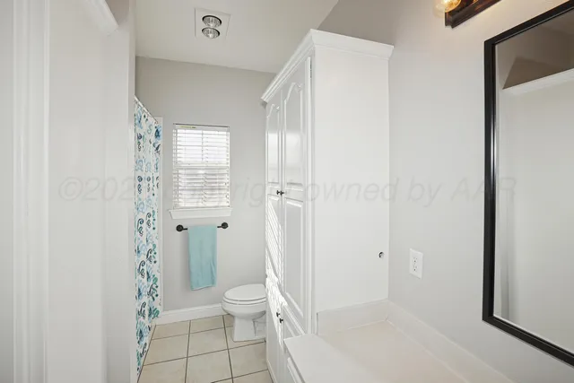 a bathroom with a granite countertop toilet a sink and shower