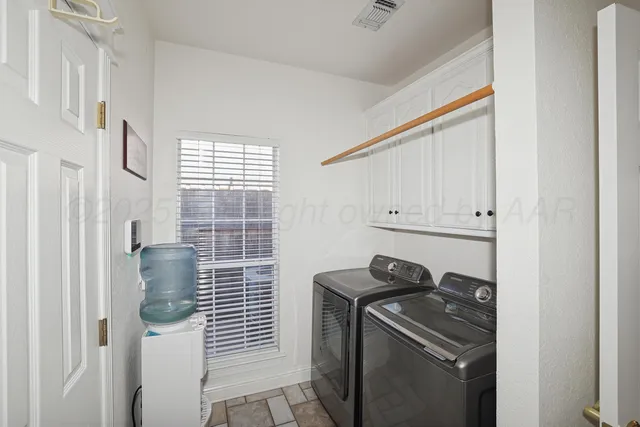 a bathroom with a sink and washing machine