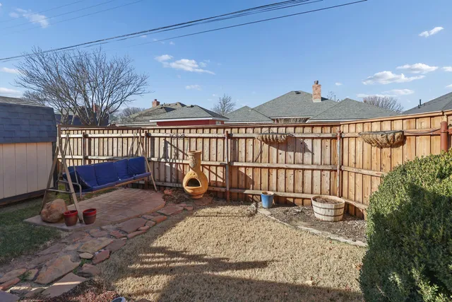 a view of a chair and table in the patio