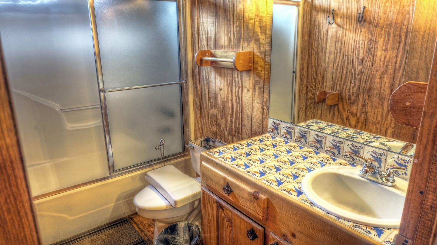 170 Cedar Lane Concan, TX 78838 - Photo 14 of 18 a bathroom with a sink and a mirror