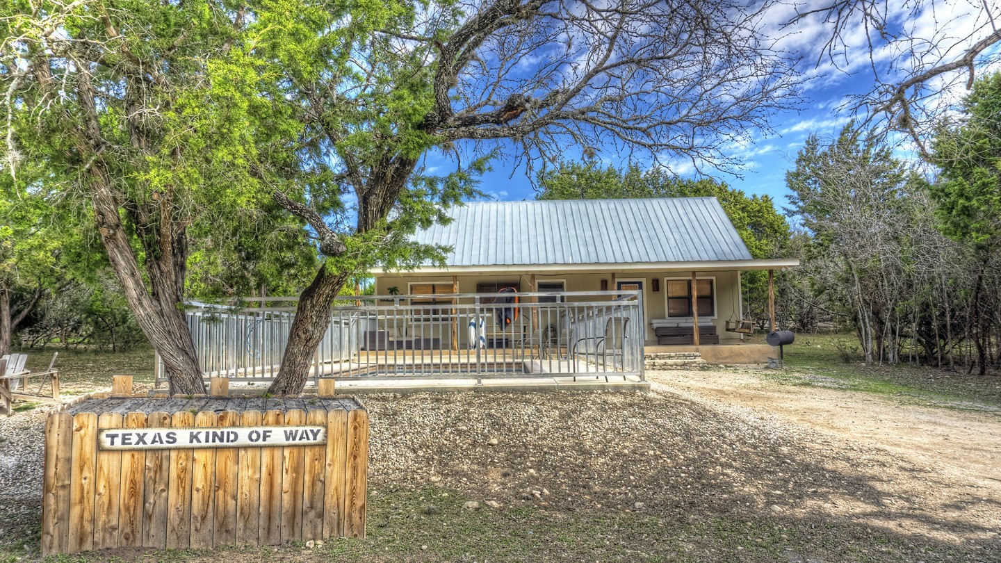 170 Cedar Lane Concan, TX 78838 - Photo 3 of 18 a backyard of a house with table and chairs