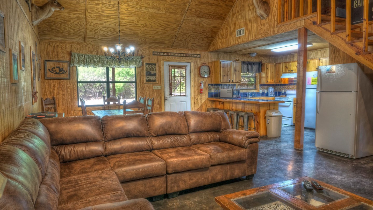 170 Cedar Lane Concan, TX 78838 - Photo 6 of 18 a living room with furniture and a chandelier