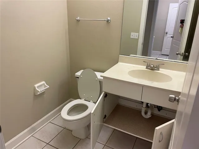 a bathroom with a toilet a sink and a mirror