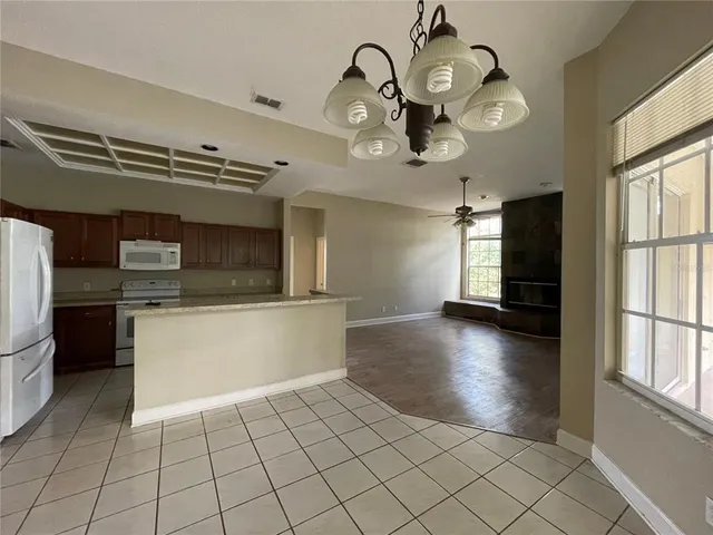 a view of a kitchen with a sink cabinets and stainless steel appliances