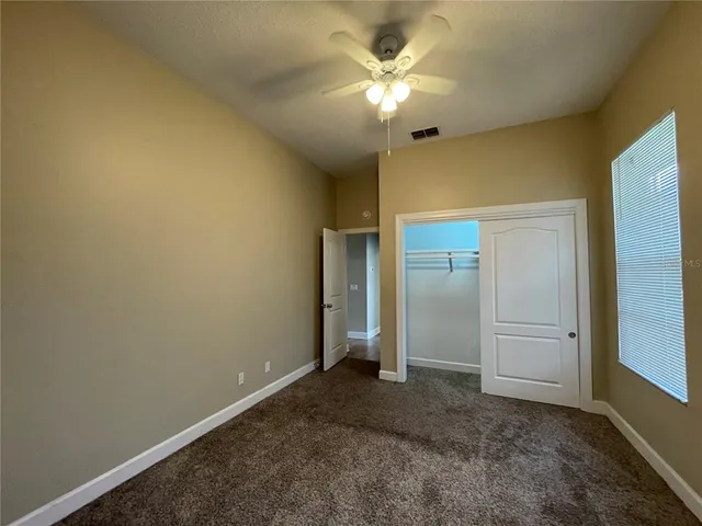 an empty room with a ceiling fan