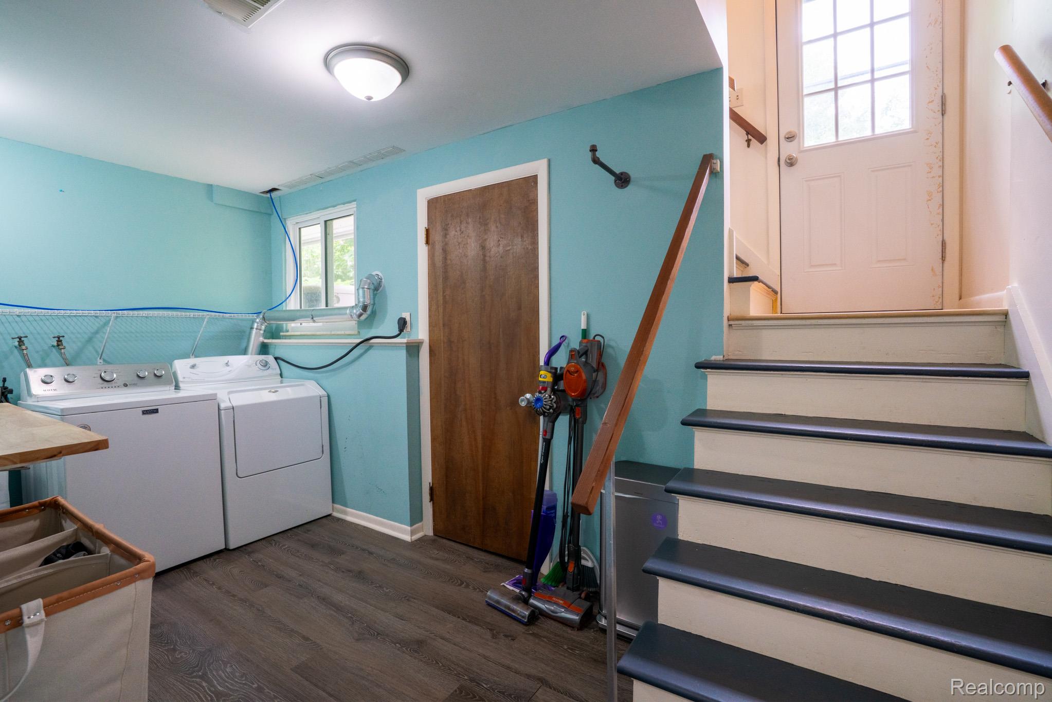 7333 Toma Road Dexter, MI 48130 - Photo 37 of 45 Dedicated laundry area featuring a washer and dryer, wood-finish flooring, and a window for natural light