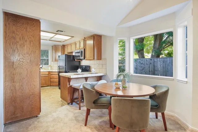 a dining room with a table and chairs
