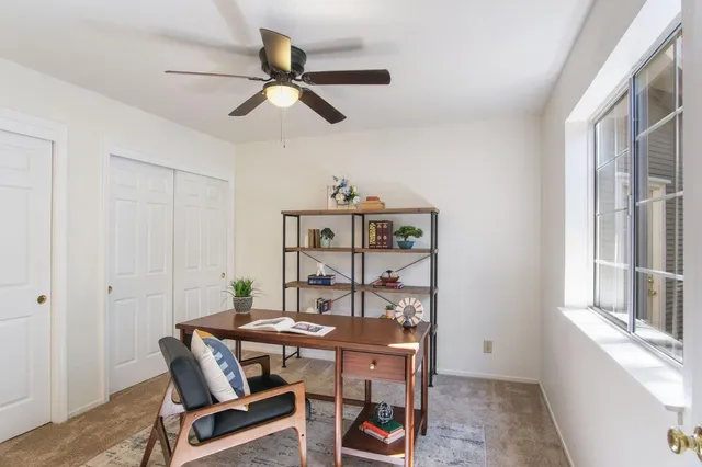 a view of a dining room with furniture and a window