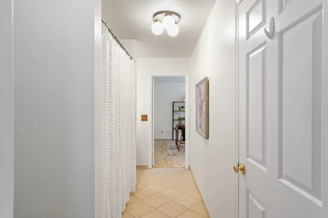 a view of a hallway with wooden shelves