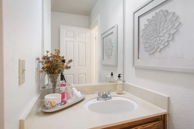 a bathroom with a two sinks and a mirror