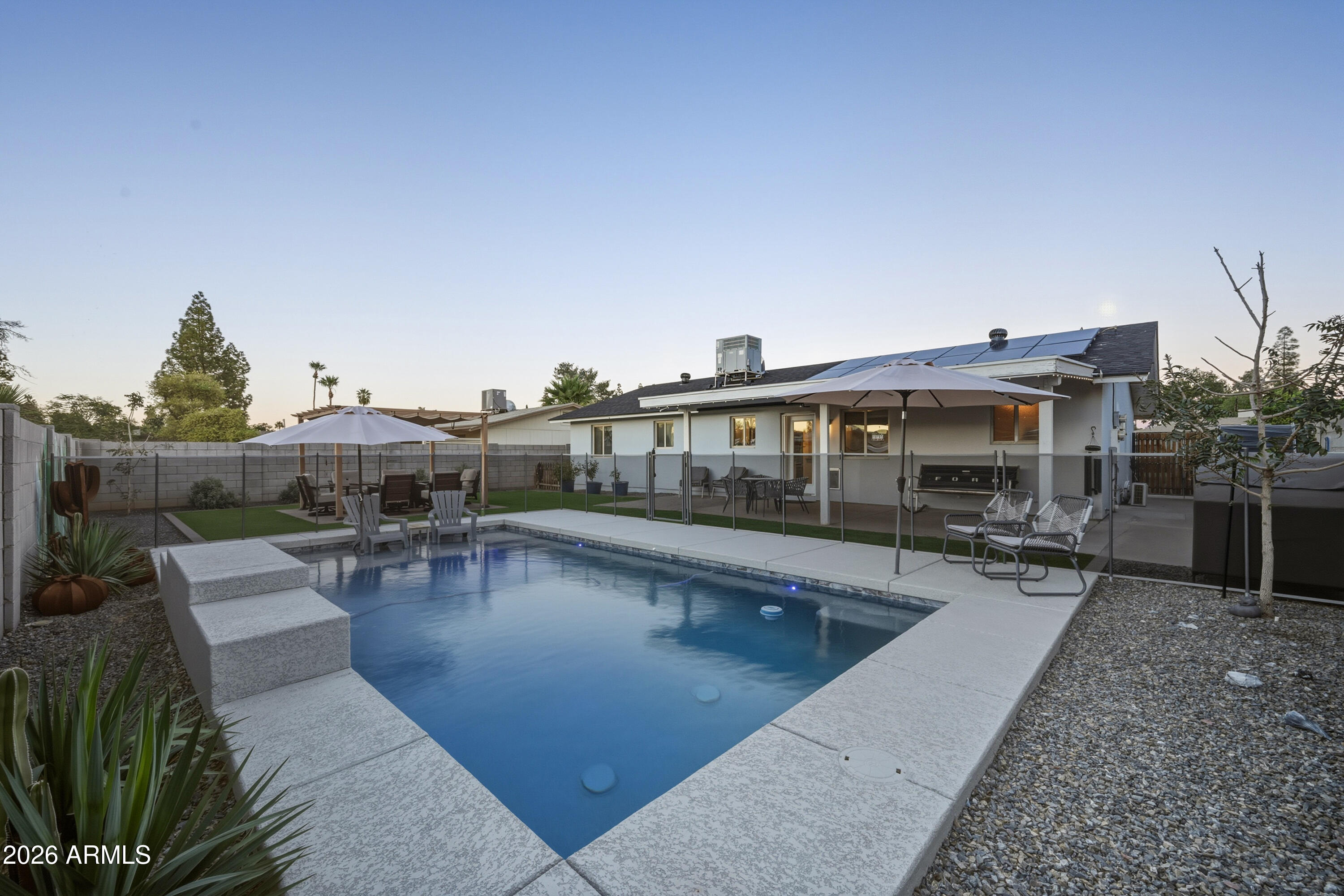 436 North Larkspur Street Gilbert, AZ 85234 - Photo 15 of 31 a view of a swimming pool with outdoor seating and plants