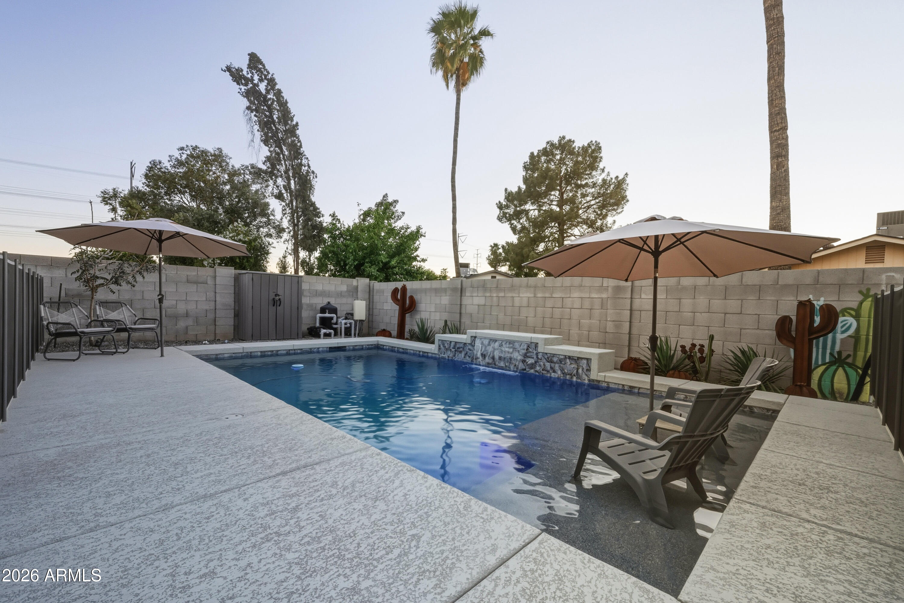 436 North Larkspur Street Gilbert, AZ 85234 - Photo 2 of 31 a view of a swimming pool with a patio and fire pit