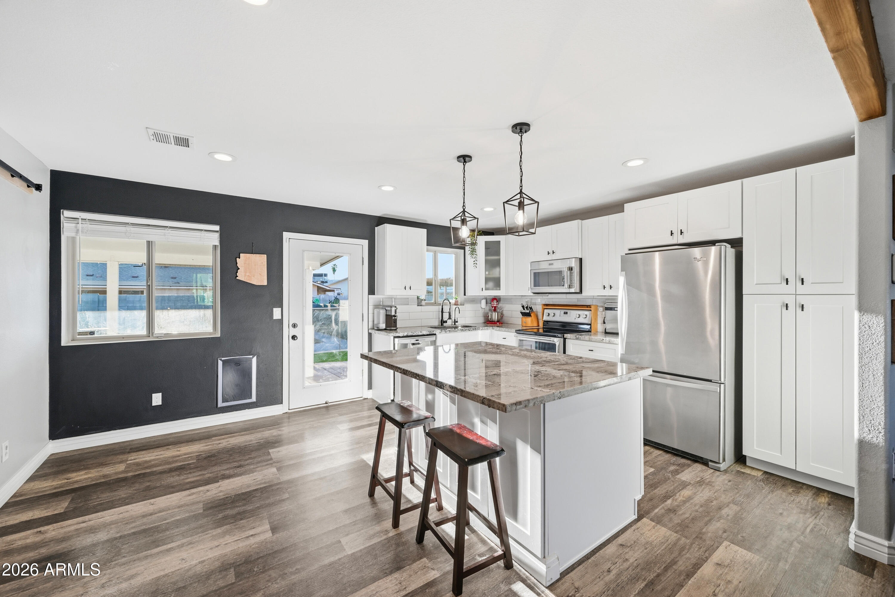 436 North Larkspur Street Gilbert, AZ 85234 - Photo 21 of 31 a kitchen with stainless steel appliances kitchen island a refrigerator and a stove