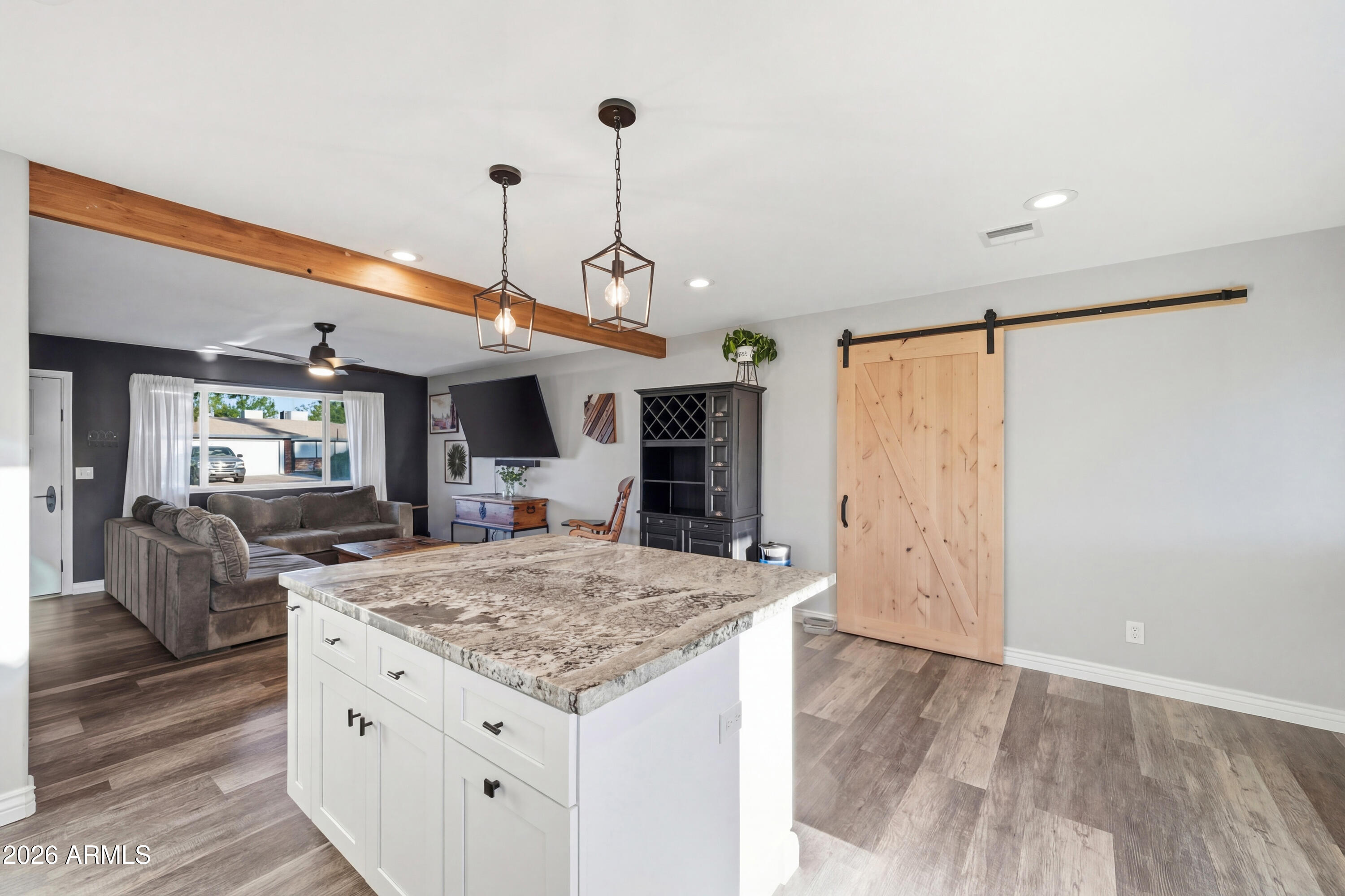 436 North Larkspur Street Gilbert, AZ 85234 - Photo 23 of 31 a open kitchen with kitchen island a refrigerator stove and wooden floor