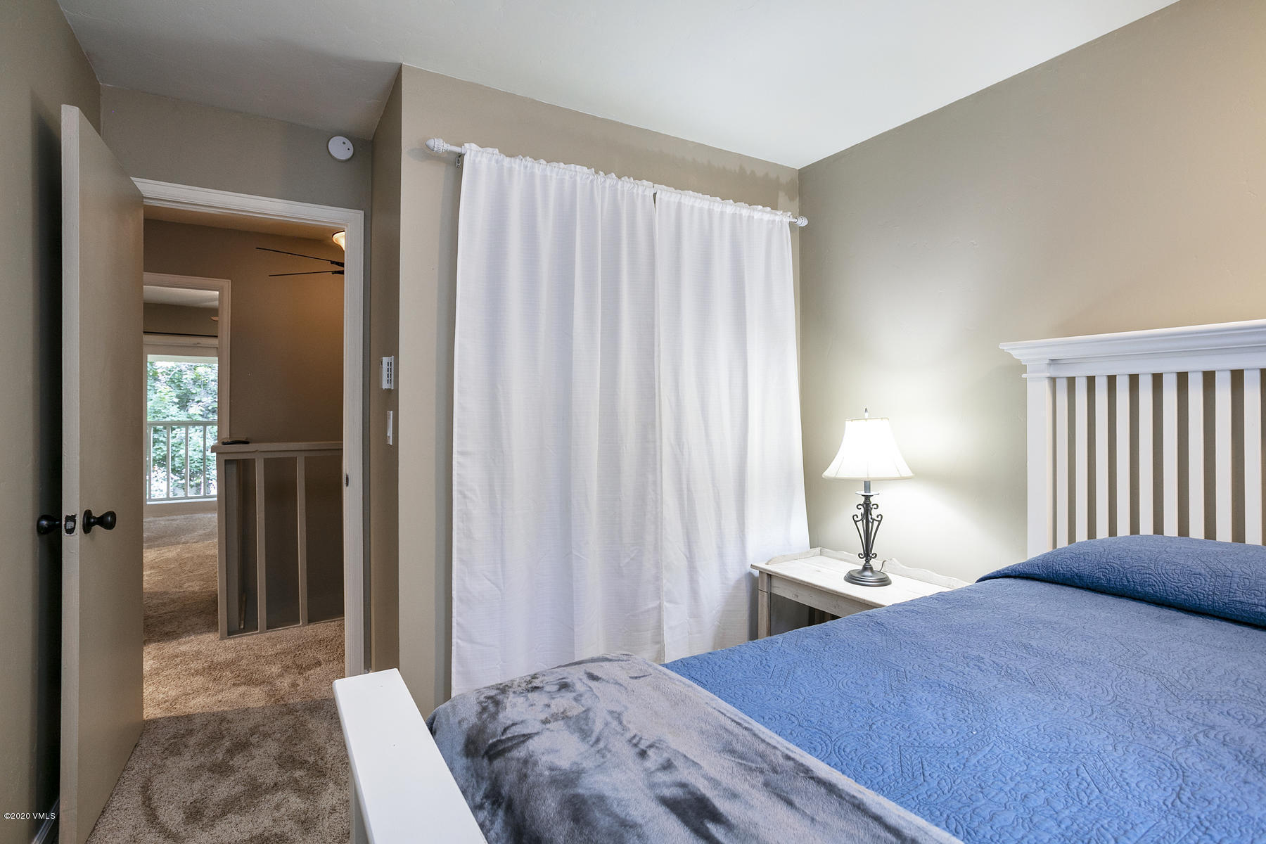 124 Eagle Road, Unit C Avon, CO 81620 - Photo 12 of 35 a bedroom with a bed and a mirror
