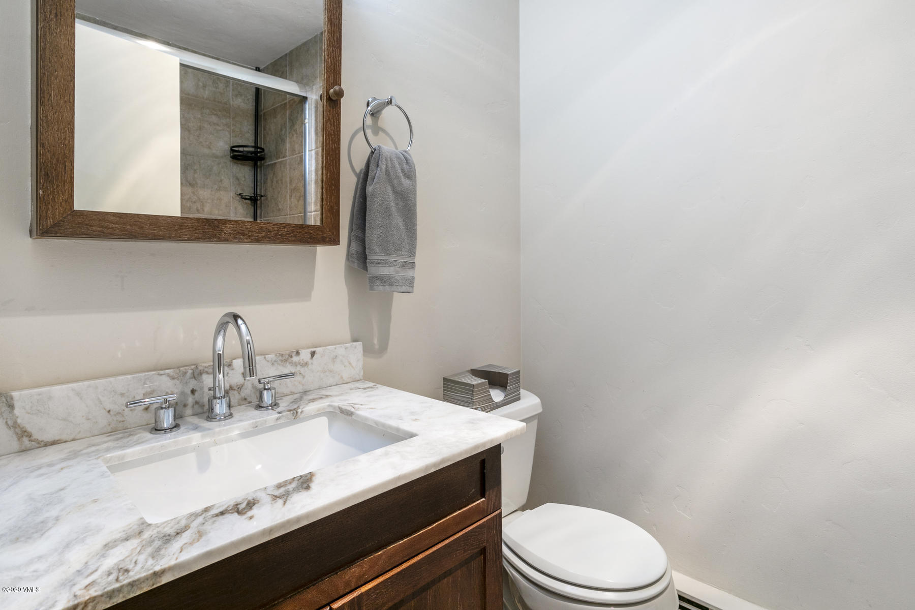 124 Eagle Road, Unit C Avon, CO 81620 - Photo 15 of 35 a bathroom with a granite countertop sink mirror vanity and toilet