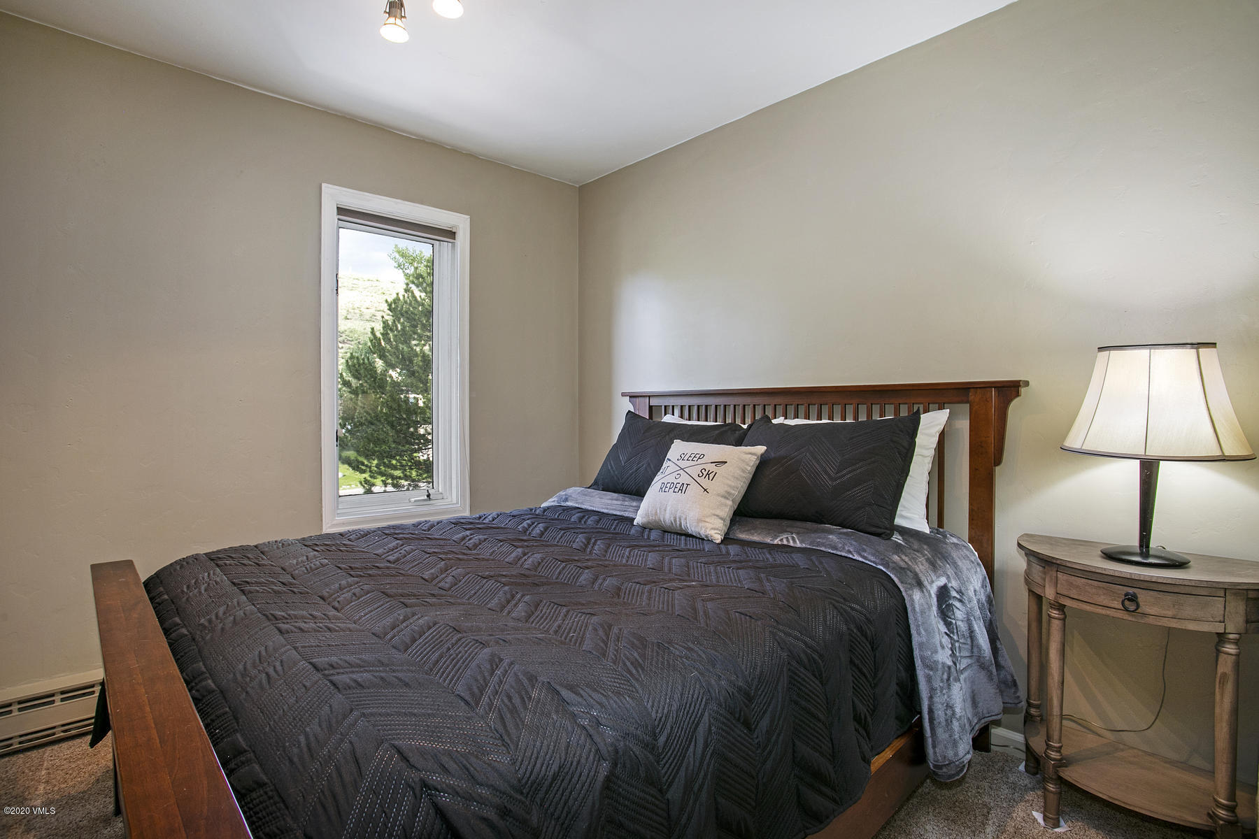 124 Eagle Road, Unit C Avon, CO 81620 - Photo 17 of 35 a bed sitting in a bedroom next to a window
