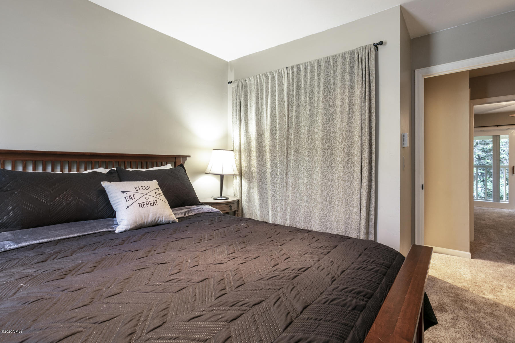 124 Eagle Road, Unit C Avon, CO 81620 - Photo 18 of 35 a bedroom with a large bed and a couch