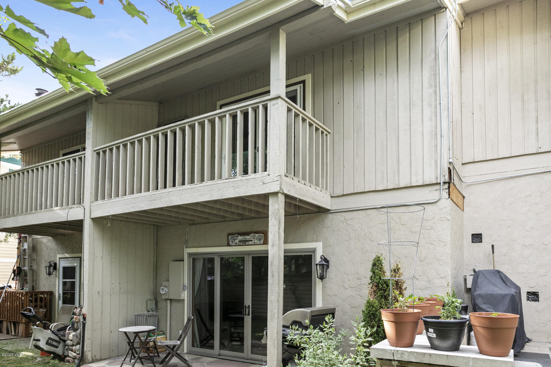 124 Eagle Road, Unit C Avon, CO 81620 - Photo 23 of 35 a view of a house with potted plants and wooden fence