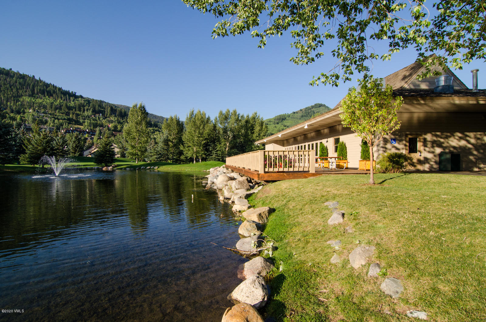 124 Eagle Road, Unit C Avon, CO 81620 - Photo 27 of 35 a view of a lake with a house in the background