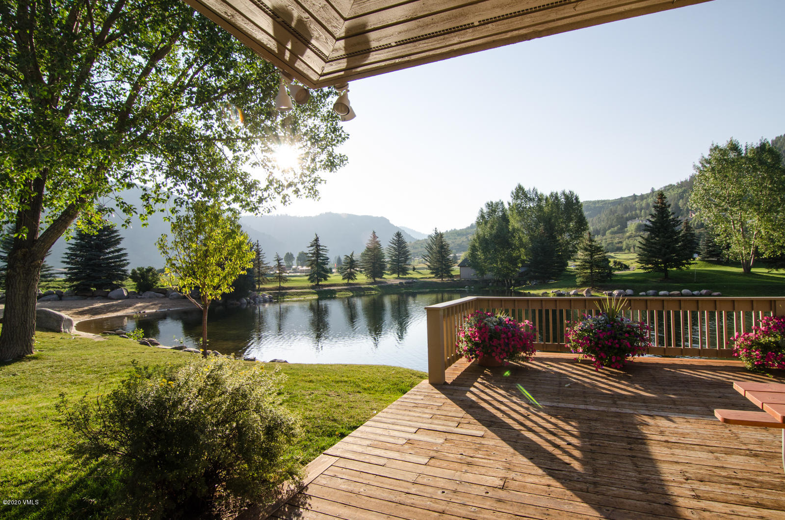 124 Eagle Road, Unit C Avon, CO 81620 - Photo 28 of 35 a view of a wooden deck with a lake view