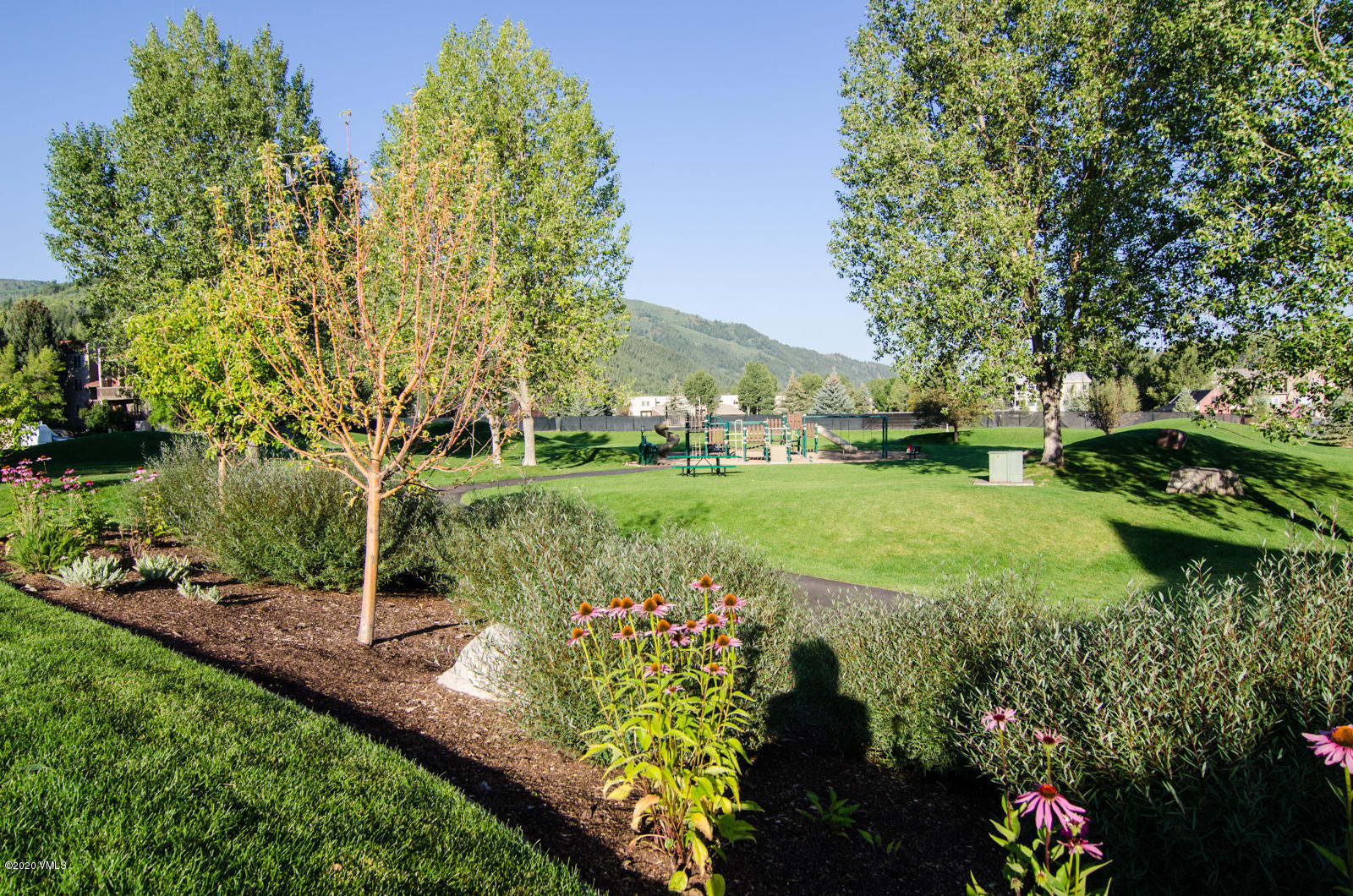 124 Eagle Road, Unit C Avon, CO 81620 - Photo 30 of 35 a view of a garden with a bench