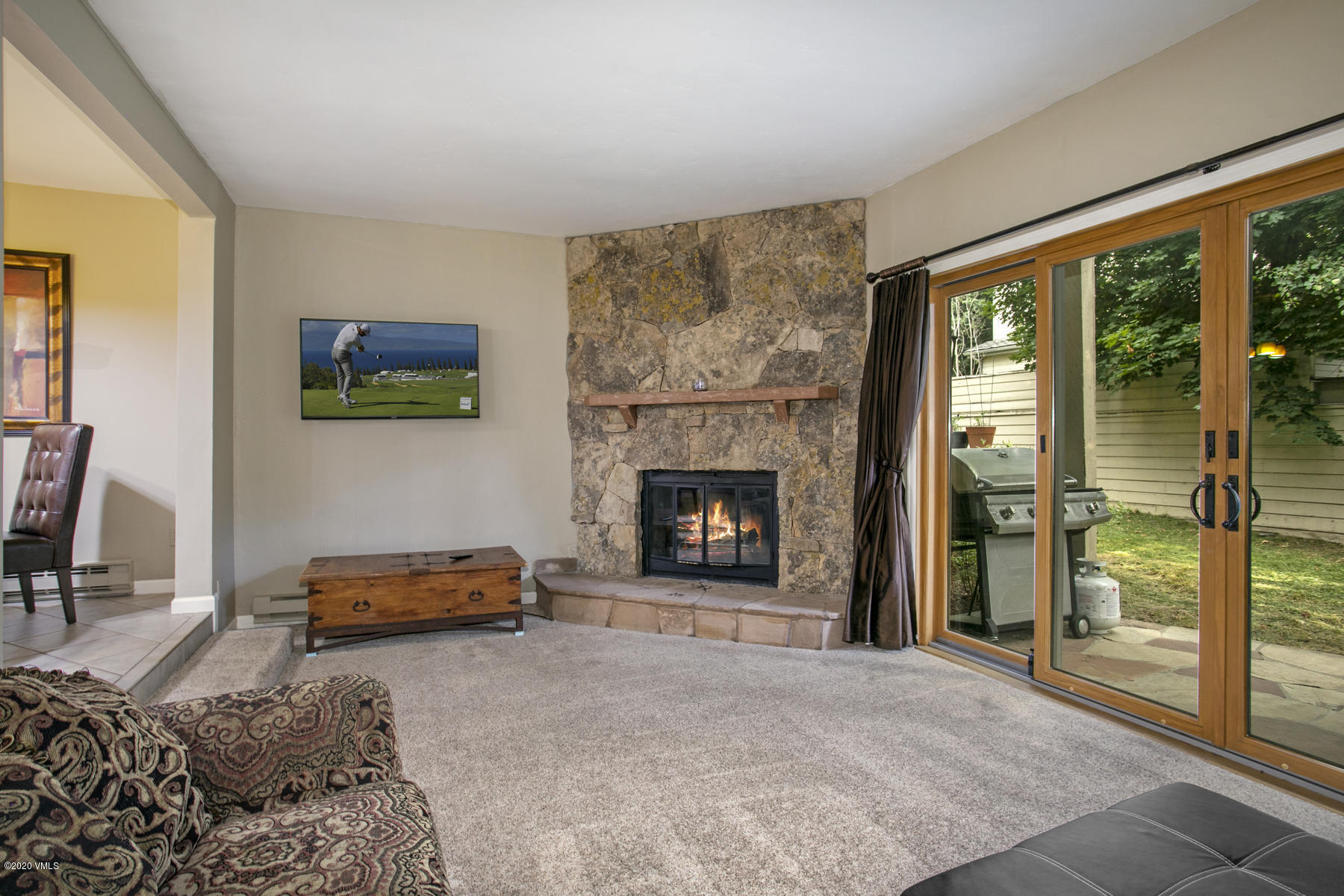 124 Eagle Road, Unit C Avon, CO 81620 - Photo 3 of 35 a living room with furniture a window and a fireplace