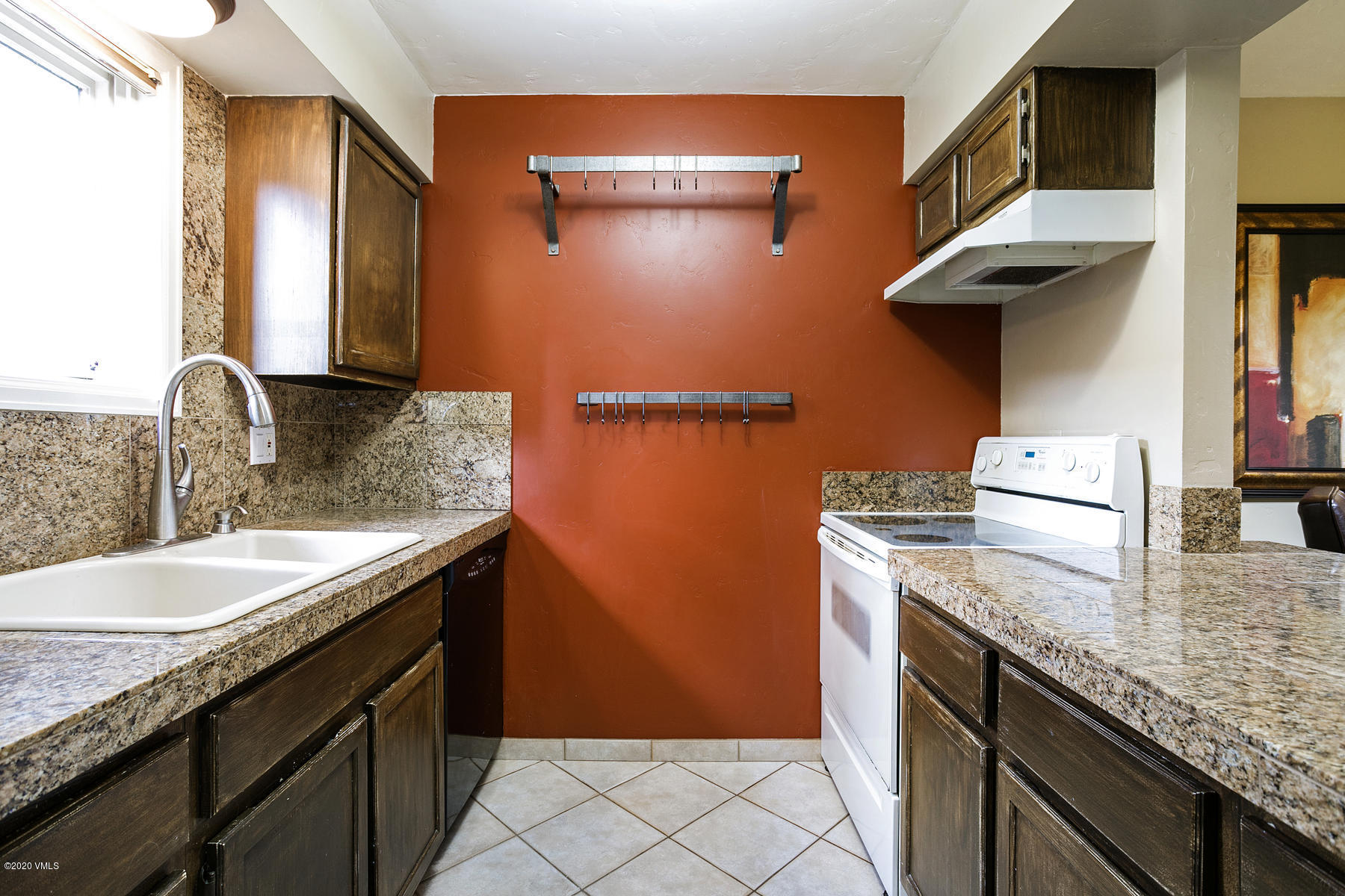 124 Eagle Road, Unit C Avon, CO 81620 - Photo 5 of 35 a kitchen with granite countertop a sink a stove and a wooden cabinets