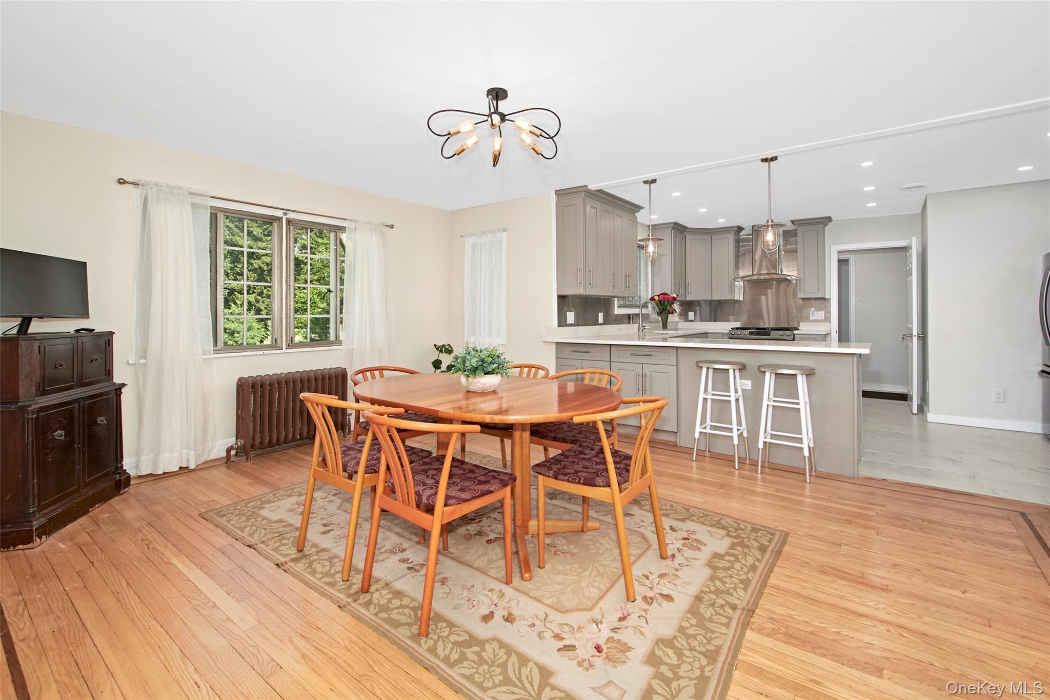 2 Byworth Road New Rochelle, NY 10804 - Photo 14 of 31 Dining area with radiator, a chandelier, light wood-style flooring, recessed lighting, and baseboards
